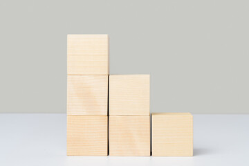 Wooden cubes arranged in the form of stairs and pyramids. Mockup for a business concept