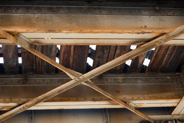 iron beams rivets and old railroad timber bridge