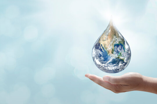 World water day. A globe in the shape of a drop of water falling onto the boy's hand on blue sea background. Elements of this image furnished by NASA
