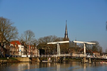 Bridges traditionally nostalgic above the rivers near the villages in the Netherlands. Seen from the water road connections between land sections and roads.