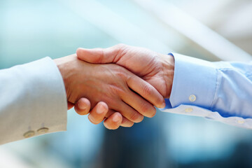 Youve got yourself a deal. Cropped shot of two people shaking hands in a corporate environment.