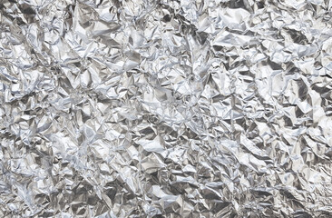 Silver foil  with shiny crumpled surface texture background