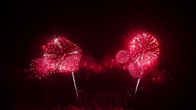 Big real fireworks display celebration and colorful New year's eve. An abstract blur of real golden shining with bokeh lights in the night sky.
