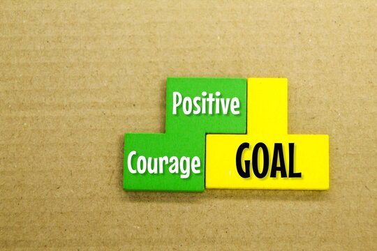 colored puzzle with the word Positive Courage Goal. the concept of self -confidence