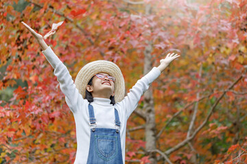 Portrait happy beautiful cute asian teenage girl with glasses in autumn park © AungMyo