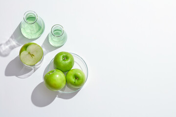 Top view of green apple decorated in petri dish in white background for advertising 