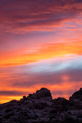 Incredible pink, orange sunset seen over desert landscape in Mojave Desert with purple, pastel tones. 
