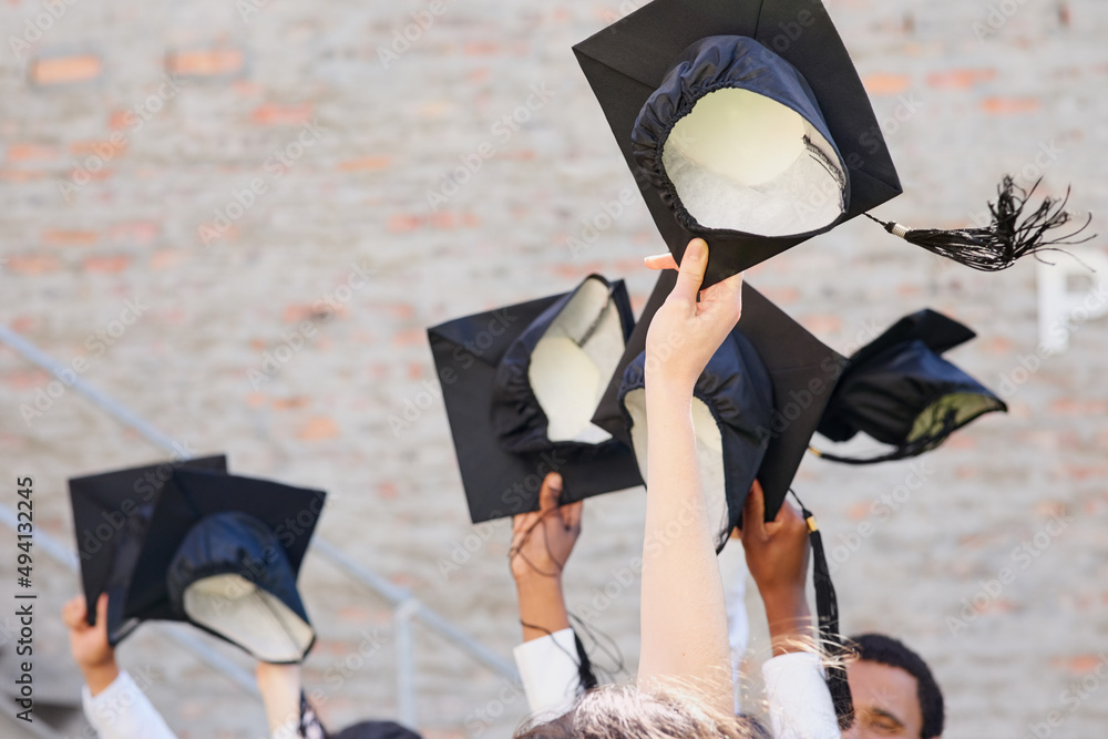 Poster time to throw those hats in the air. shot of a group of students throwing their caps into the air on
