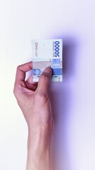 Indonesian Rupiah the official currency of Indonesia. Man's hand is making a payment. Male hand showing Indonesian Rupiah Note. Business Investment Economy and Finance Concept Uang 50000 50.000 Rupiah