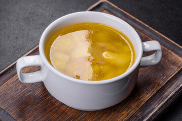 Fresh pea soup in bowl on black background. Cooking at home