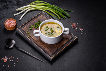 Fresh pea soup in bowl on black background. Cooking at home