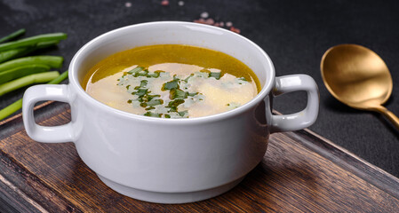 Fresh pea soup in bowl on black background. Cooking at home