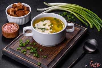 Fresh pea soup in bowl on black background. Cooking at home