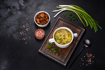 Fresh pea soup in bowl on black background. Cooking at home