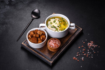 Fresh pea soup in bowl on black background. Cooking at home