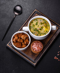 Fresh pea soup in bowl on black background. Cooking at home