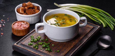 Fresh pea soup in bowl on black background. Cooking at home