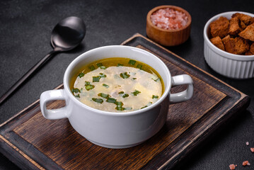 Fresh pea soup in bowl on black background. Cooking at home