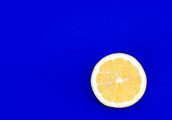 half a lemon on a blue background