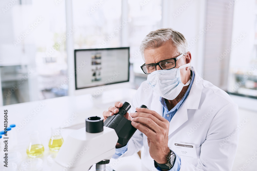 Poster science stimulates our natural curiosity of the world. portrait of a mature scientist using a micros