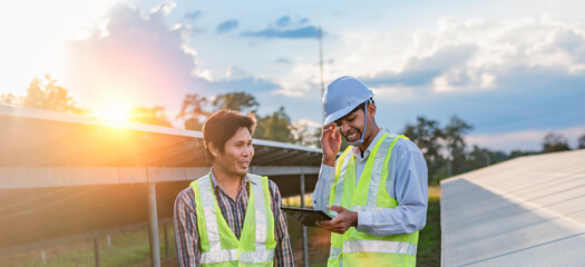 Architectural engineer working on solar panels and photovoltaic farms at a construction site, meeting, discussing, designing, planning, clean energy concept.