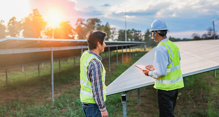 Architectural engineer working on solar panels and photovoltaic farms at a construction site, meeting, discussing, designing, planning, clean energy concept.