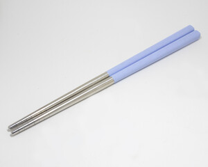 Stainless steel chopsticks with light purple plastic handle isolated on white background