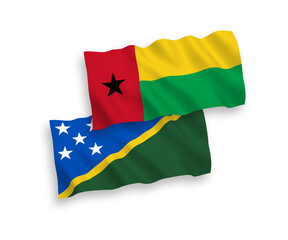 Flags of Solomon Islands and Republic of Guinea Bissau on a white background