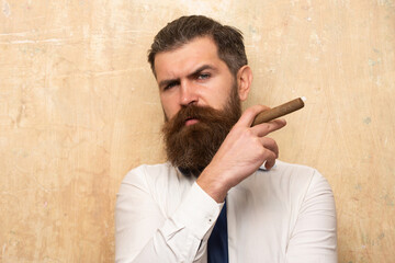 Brutal man smoking cigar, handsome serious male model.