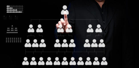 A businessman stands in front of a virtual hierarchy diagram in a company. Search for talented...