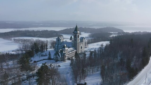 Dramatic View Of St. Benedict Abbey And The Quiet Scenery In St. Benoit Du Lac In Winter - aerial shot