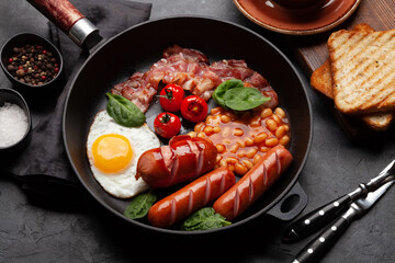 English breakfast with fried eggs, beans, bacon and sausages