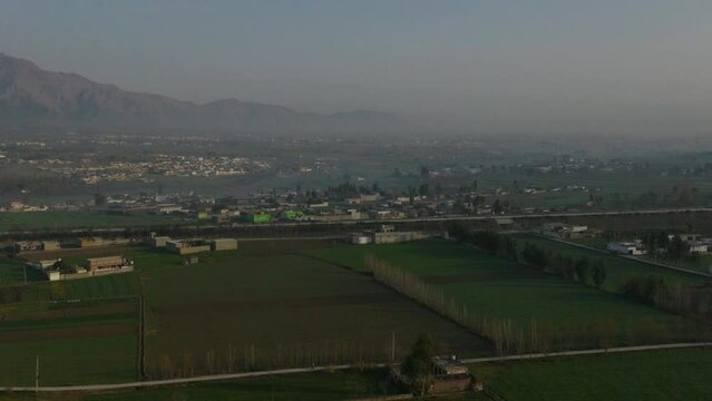 Aerial Drone Flying Over Rural Abbottabad Farm Fields Circle Dolly View Of Hazara M 15 Motorway 