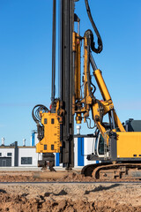 Powerful hydraulic drilling rig at a construction site. The device of pile foundations. Bored piles. Heavy construction equipment.