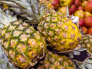 Fresh pineapples with leaves in a supermarket  . Close up