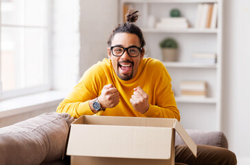 African American man cheering about delivered parcel