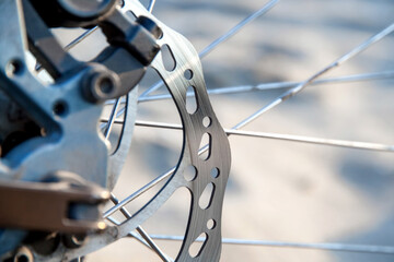 Fototapeta na wymiar Used mountain bike disc brake close-up. Blurry background