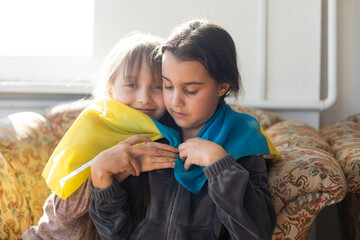 Fototapeta premium Two little child girls are sitting in shelter during bombings