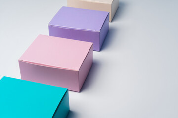 Pile of colorful cardboard boxes on white background