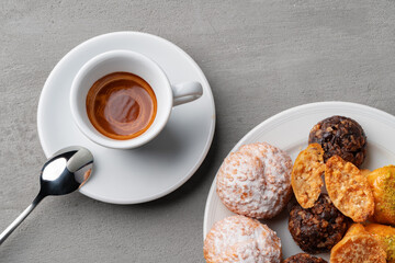 Cup of espresso and cookies on a gray table