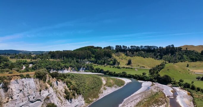 Aerial over dramatic Rangitikei river landscape to State Highway One traffic