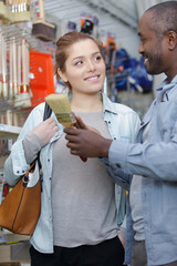 a female customer buying paint brushes