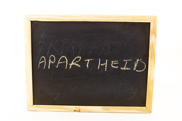 The term APARTHEID visually displayed on a blackboard