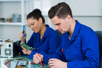 apprentices electronicians working on circuits