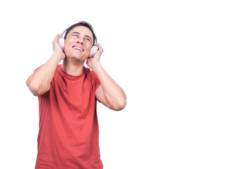 Cheerful man listening to music from headphones
