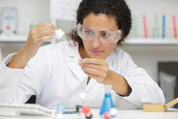 woman working with pipettes in a lab