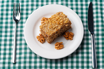 Piece of nut cake on white plate