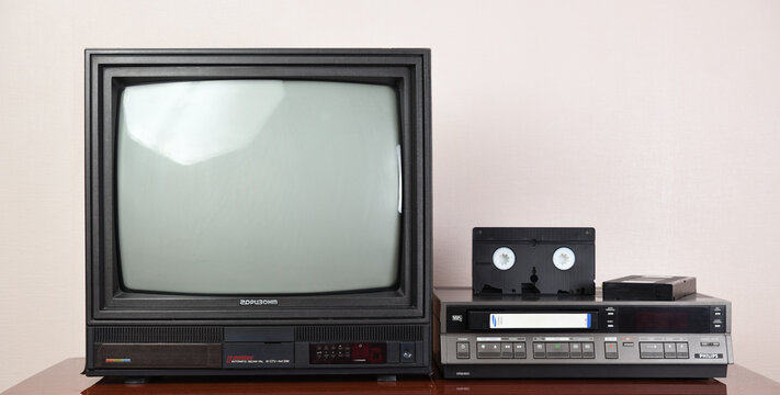 Berlin, Germany 08.01.2021: Old black HORIZON TV with built-in and vintage Philips VR6460 video recorder from the 1980s, 1990s, 2000s against the background of  wallpaper.