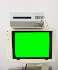 Old ultrasound monitor with green screen and printer. 