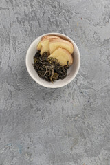 Green tea in a small bowl with fresh ginger